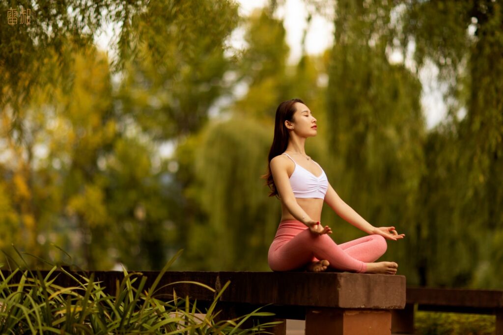 woman doing a relaxation exercise in a park