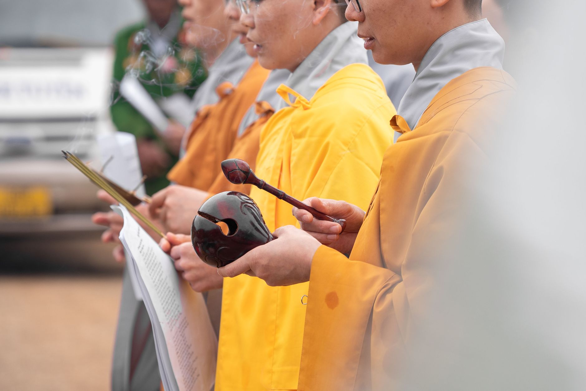 monks in orange robes practicing ceremony