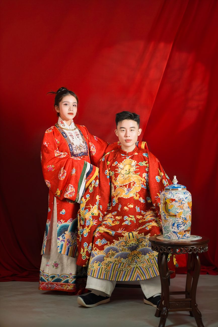 traditional chinese attire portrait with red backdrop