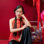 elegant woman in traditional red dress with braids
