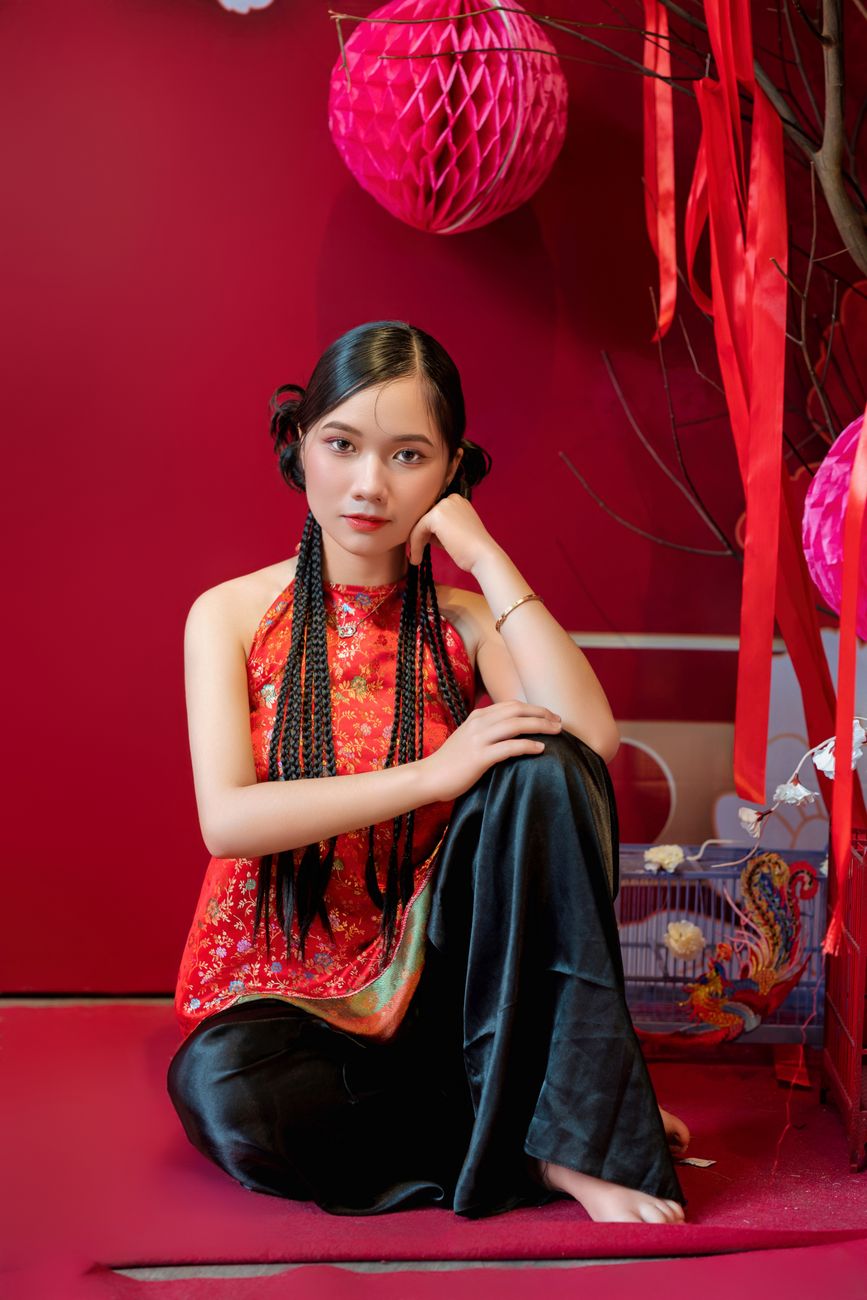 elegant woman in traditional red dress with braids