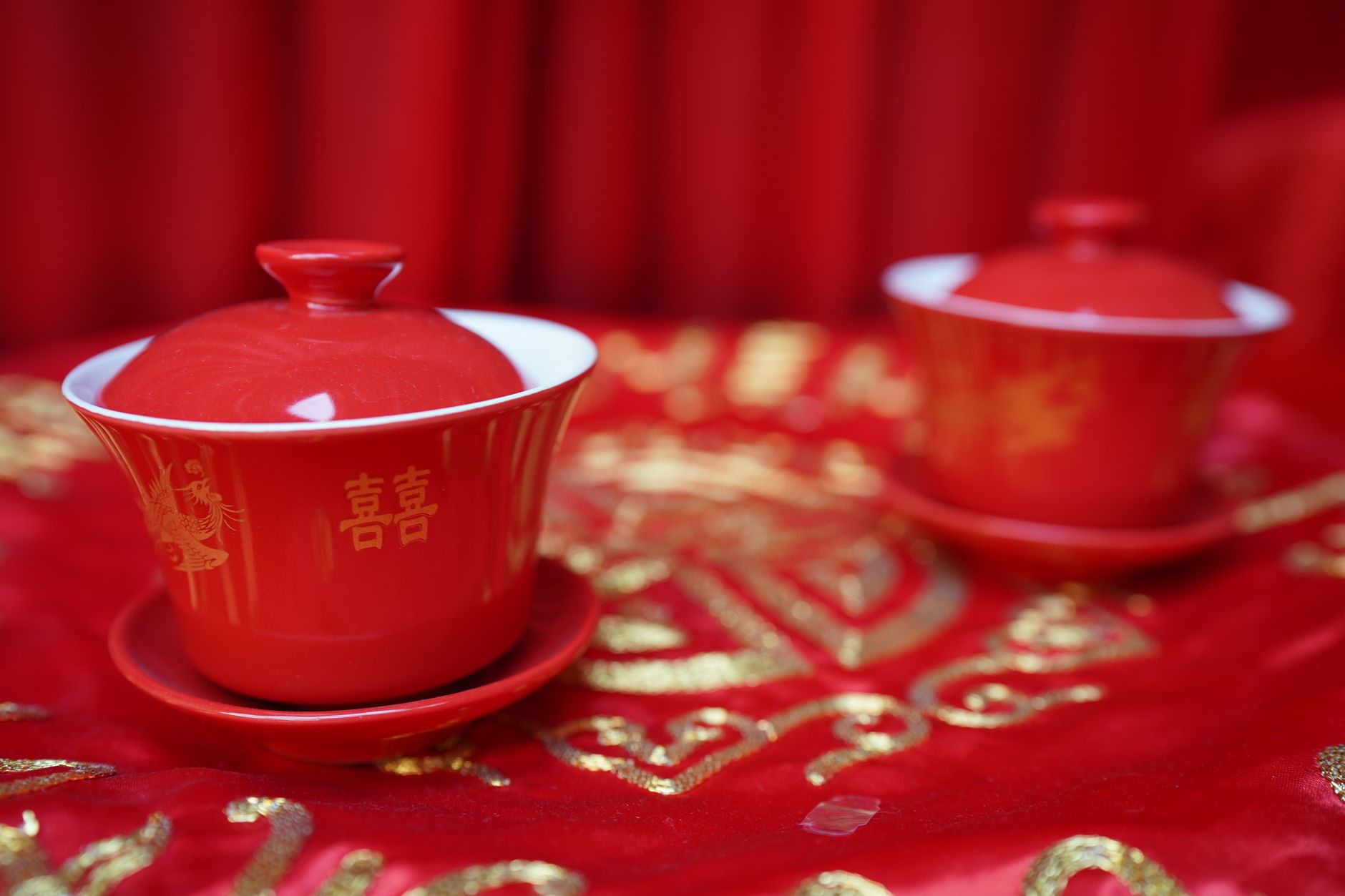 red ceramic mug on red textile